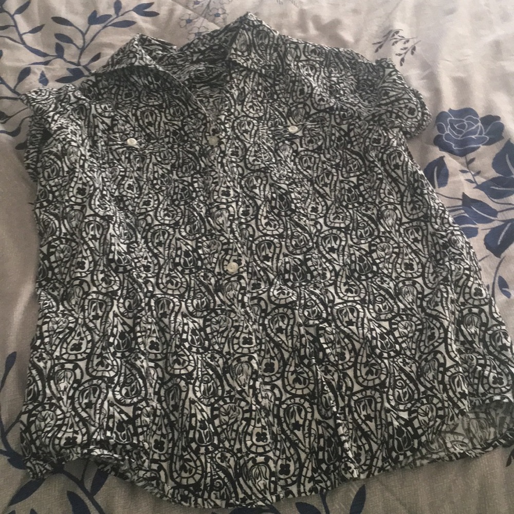 Collared dress shirt with half sleeves, buttons up and has pockets